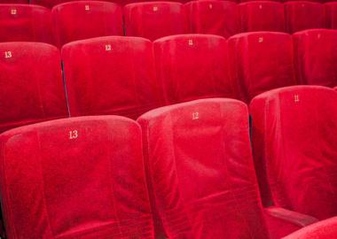 Row of red empty seats at a venue